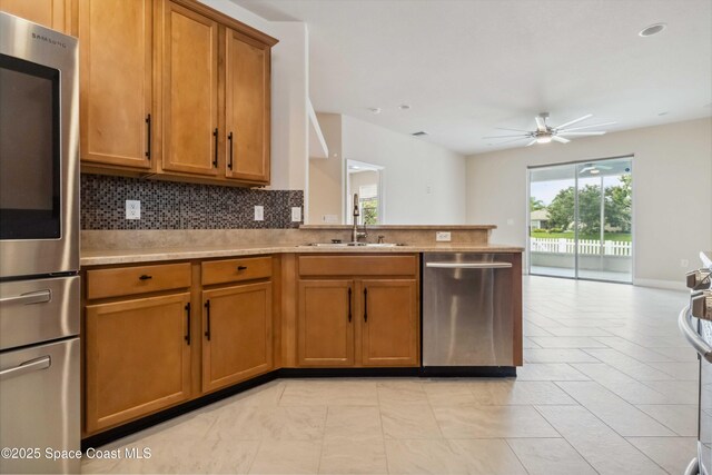 2262 Lune Ct, West Melbourne, FL 32904 - kitchen with appliances with stainless steel finishes, a sink, plenty of natural light, and a ceiling fan