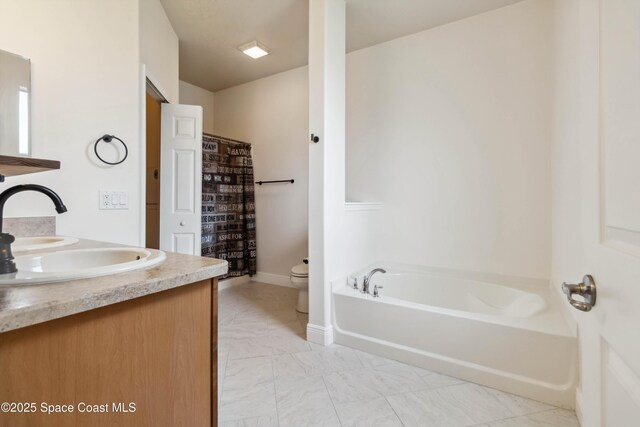 2262 Lune Ct, West Melbourne, FL 32904 - full bath with toilet, a garden tub, double vanity, and marble look tiles