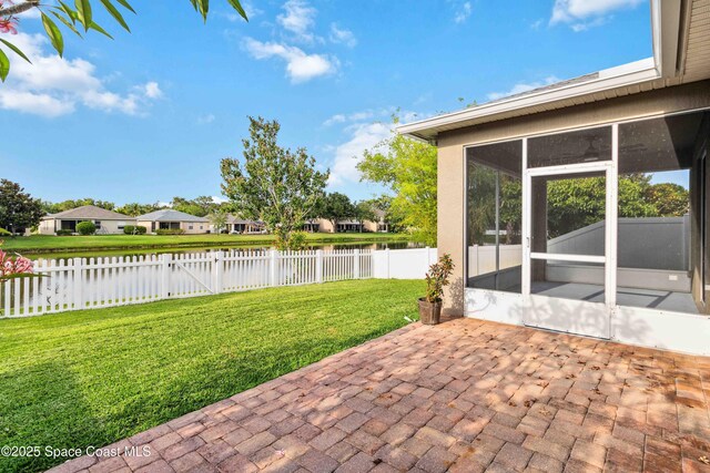 2262 Lune Ct, West Melbourne, FL 32904 - view of patio with a water view, a sunroom, and a residential view