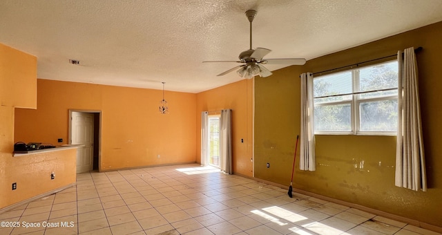4155 Devoe Ave, Cocoa, FL 32927 - empty room with ceiling fan, a textured ceiling, light tile patterned flooring, and baseboards
