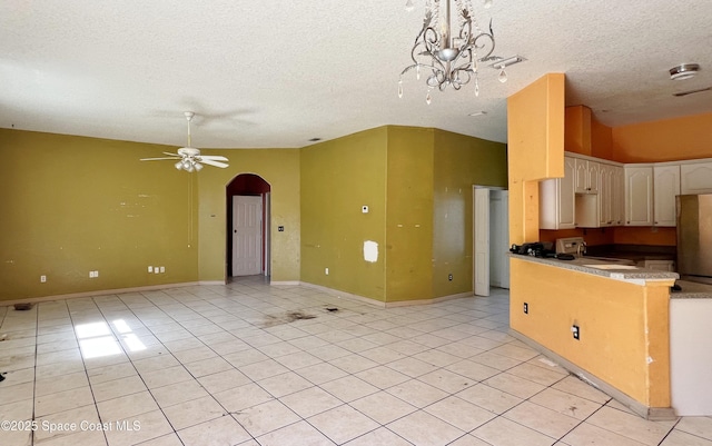 4155 Devoe Ave, Cocoa, FL 32927 - kitchen with arched walkways, freestanding refrigerator, light tile patterned floors, a textured ceiling, and a sink