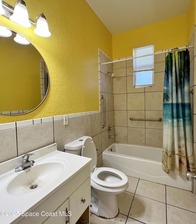 4155 Devoe Ave, Cocoa, FL 32927 - full bath with a textured wall, tile walls, shower / tub combo, tile patterned floors, and toilet