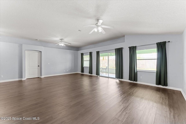 3817 Sunbeam Ct, Merritt Island, FL 32953 - spare room with ceiling fan, a textured ceiling, dark wood-style floors, vaulted ceiling, and baseboards