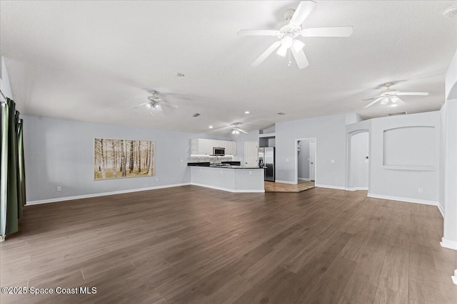 3817 Sunbeam Ct, Merritt Island, FL 32953 - unfurnished living room featuring ceiling fan, dark wood-style floors, baseboards, and lofted ceiling