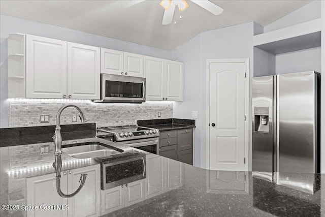 3817 Sunbeam Ct, Merritt Island, FL 32953 - kitchen featuring appliances with stainless steel finishes, dark stone counters, a sink, and white cabinets