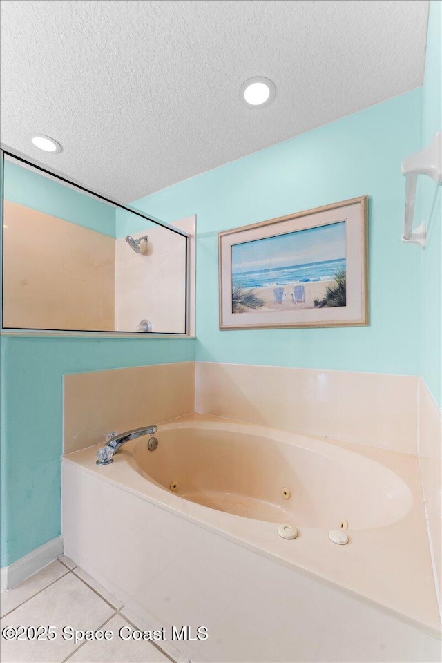 3817 Sunbeam Ct, Merritt Island, FL 32953 - bathroom with a textured ceiling, a tub with jets, and tile patterned floors