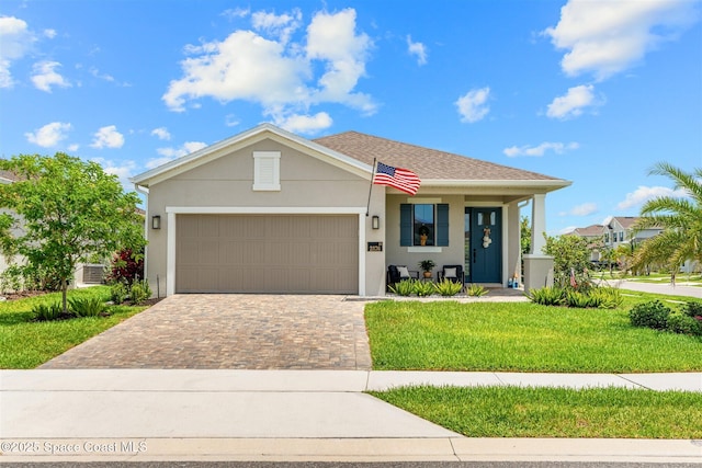 2376 Kamin Dr, Melbourne, FL 32940 - single story home with a front lawn, decorative driveway, an attached garage, and stucco siding