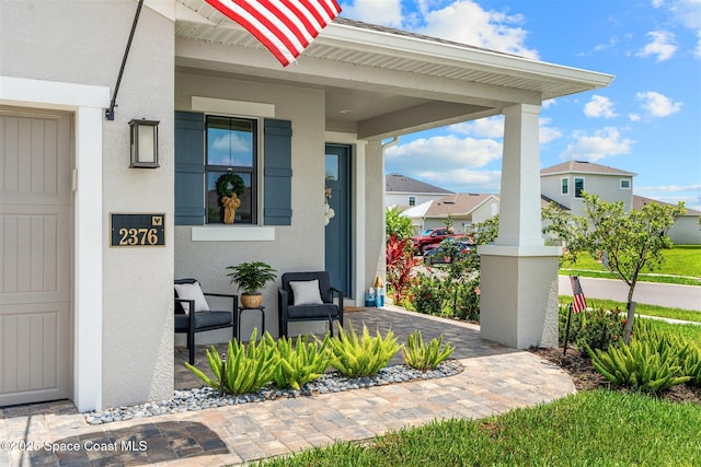2376 Kamin Dr, Melbourne, FL 32940 - doorway to property featuring stucco siding and a porch