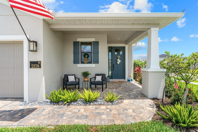 2376 Kamin Dr, Melbourne, FL 32940 - entrance to property with stucco siding, covered porch, and an attached garage