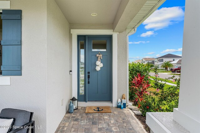 2376 Kamin Dr, Melbourne, FL 32940 - property entrance featuring stucco siding and a residential view