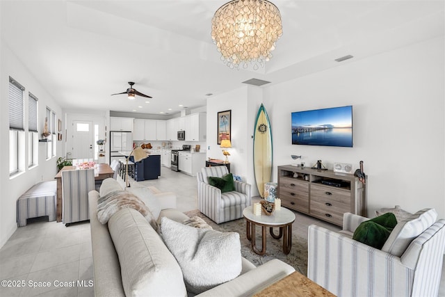 2376 Kamin Dr, Melbourne, FL 32940 - living area with light tile patterned floors, a chandelier, a ceiling fan, and recessed lighting