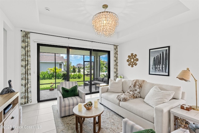 2376 Kamin Dr, Melbourne, FL 32940 - living area with a raised ceiling, a chandelier, and light tile patterned floors