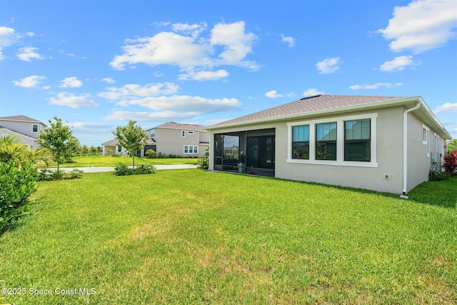 2376 Kamin Dr, Melbourne, FL 32940 - back of property with a yard, a sunroom, and stucco siding