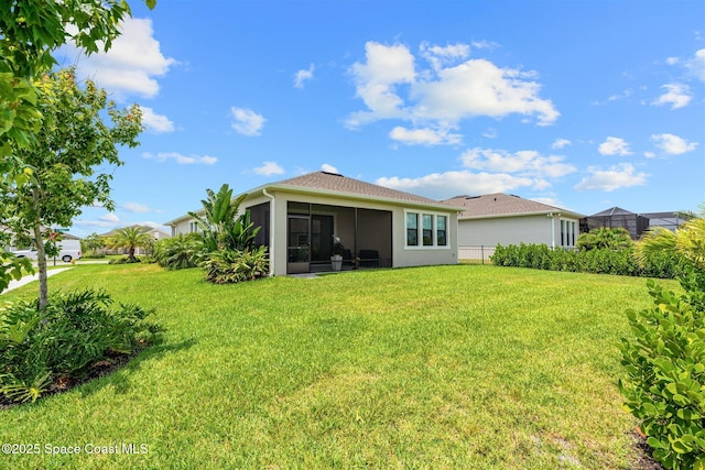 2376 Kamin Dr, Melbourne, FL 32940 - back of property with a yard, a sunroom, and stucco siding