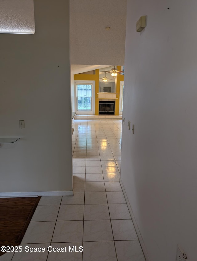 862 Aachen Ave NW, Palm Bay, FL 32907 - corridor with light tile patterned floors, baseboards, and a towering ceiling