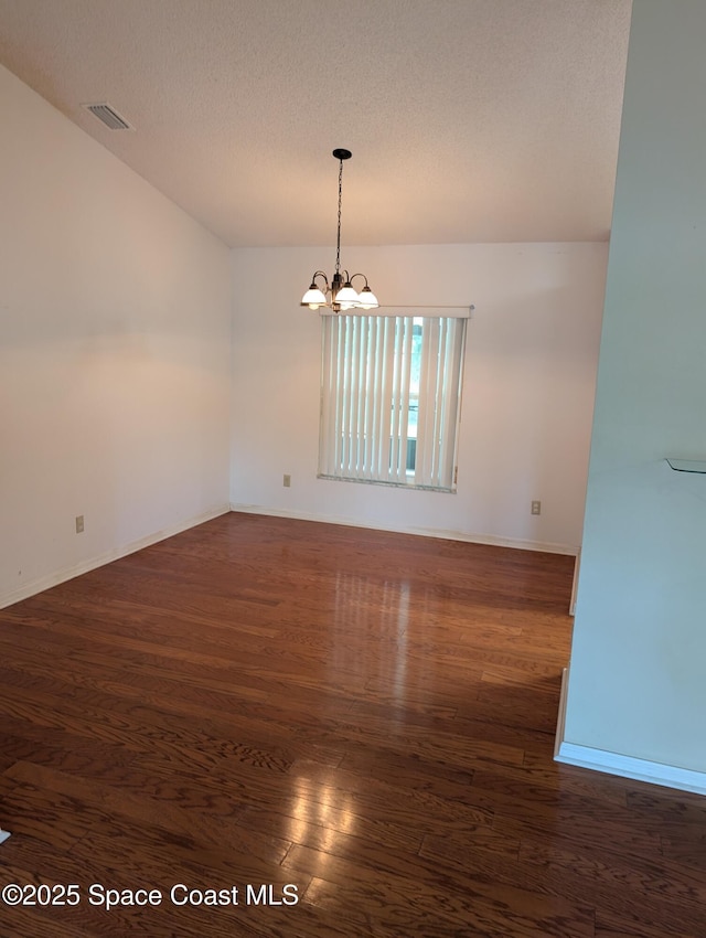 862 Aachen Ave NW, Palm Bay, FL 32907 - unfurnished room with dark wood-style floors, a chandelier, and baseboards