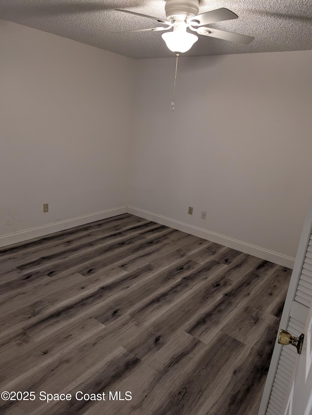 862 Aachen Ave NW, Palm Bay, FL 32907 - unfurnished room with ceiling fan, dark wood-type flooring, a textured ceiling, and baseboards