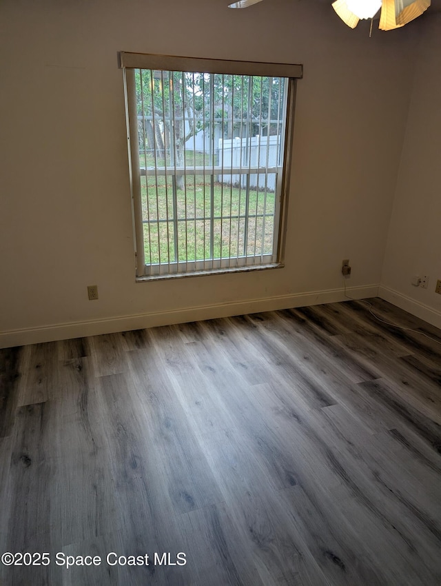 862 Aachen Ave NW, Palm Bay, FL 32907 - spare room with baseboards, wood finished floors, and a ceiling fan