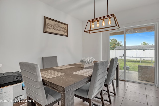 1005 Slocum St NW, Palm Bay, FL 32907 - dining space with light tile patterned floors and a chandelier