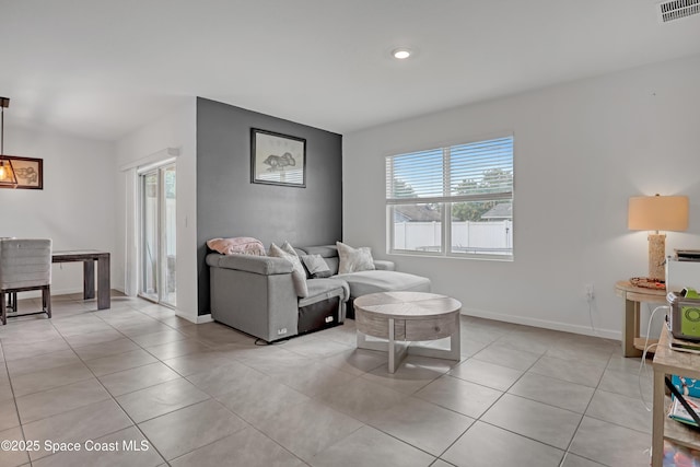 1005 Slocum St NW, Palm Bay, FL 32907 - living room featuring light tile patterned flooring, baseboards, and recessed lighting