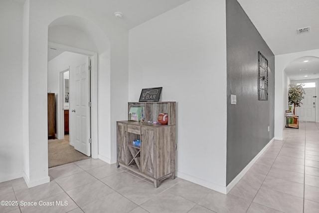 1005 Slocum St NW, Palm Bay, FL 32907 - corridor with arched walkways, light tile patterned floors, and baseboards