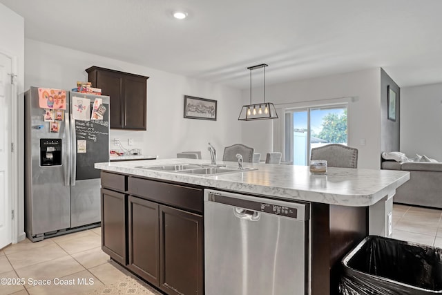 1005 Slocum St NW, Palm Bay, FL 32907 - kitchen featuring appliances with stainless steel finishes, a sink, light tile patterned flooring, and light countertops