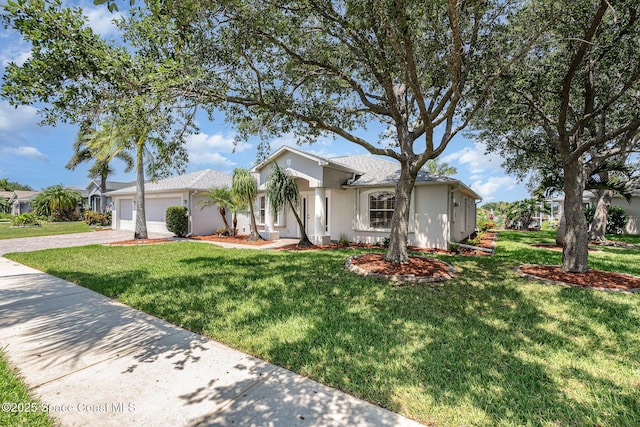 1555 Knoll Ridge Dr, Melbourne, FL 32940 - ranch-style house featuring driveway, an attached garage, a front yard, and stucco siding