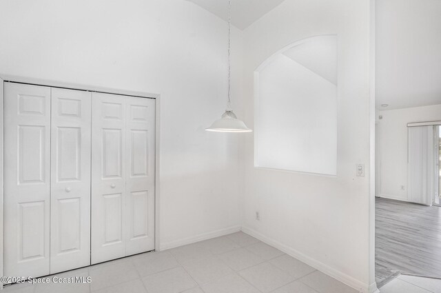 1555 Knoll Ridge Dr, Melbourne, FL 32940 - unfurnished bedroom with baseboards, a closet, and lofted ceiling