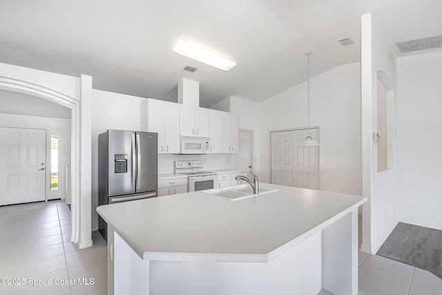 1555 Knoll Ridge Dr, Melbourne, FL 32940 - kitchen with white appliances, a sink, light tile patterned flooring, lofted ceiling, and a kitchen island with sink