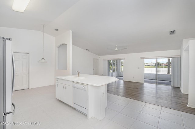 1555 Knoll Ridge Dr, Melbourne, FL 32940 - kitchen featuring dishwasher, freestanding refrigerator, a sink, open floor plan, and lofted ceiling