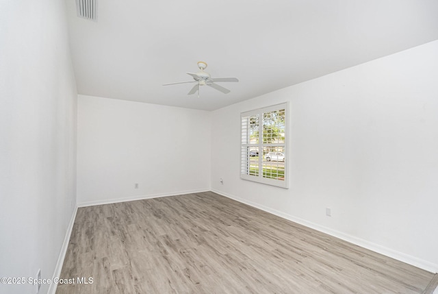 1555 Knoll Ridge Dr, Melbourne, FL 32940 - spare room with wood finished floors, a ceiling fan, and baseboards