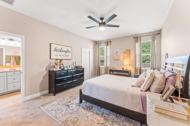 1641 Earlham Ave NW, Palm Bay, FL 32907 - bedroom featuring light colored carpet, baseboards, ensuite bath, a textured ceiling, and a ceiling fan