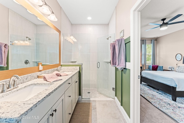 1641 Earlham Ave NW, Palm Bay, FL 32907 - ensuite bathroom featuring double vanity, a shower stall, and a ceiling fan