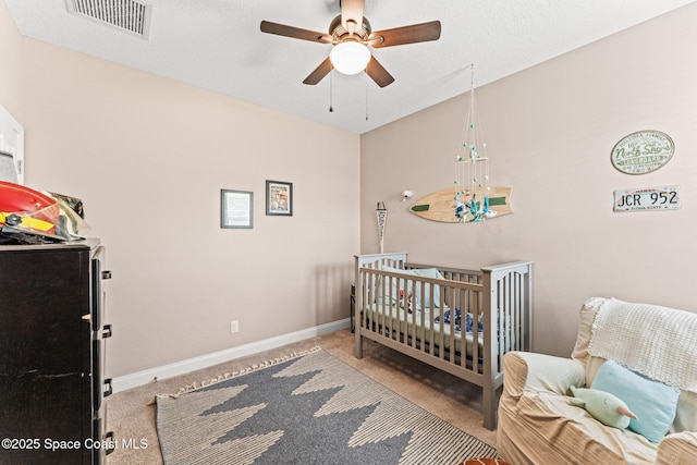 1641 Earlham Ave NW, Palm Bay, FL 32907 - carpeted bedroom featuring a crib, baseboards, and a ceiling fan