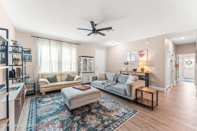 1641 Earlham Ave NW, Palm Bay, FL 32907 - living room with ceiling fan, healthy amount of natural light, light wood-style flooring, and baseboards