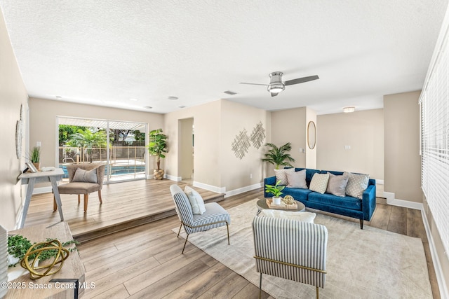 475 Park Ave, Satellite Beach, FL 32937 - living room featuring wood finished floors, baseboards, ceiling fan, and a textured ceiling