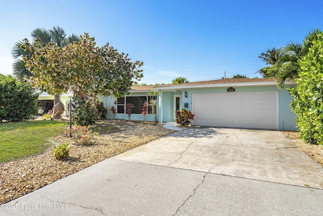 475 Park Ave, Satellite Beach, FL 32937 - view of front of house with stucco siding, a garage, and concrete driveway