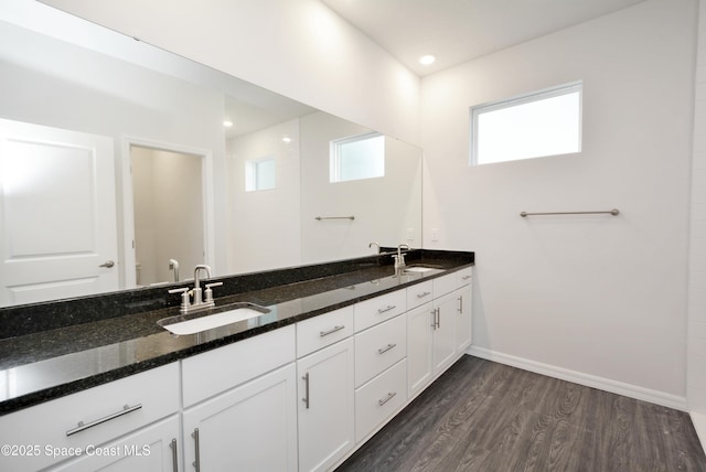 883 Parrotfish St SW, Palm Bay, FL 32908 - full bathroom with double vanity, wood finished floors, baseboards, and toilet