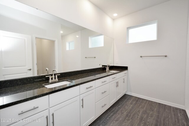 883 Parrotfish St SW, Palm Bay, FL 32908 - full bathroom with double vanity, wood finished floors, baseboards, and toilet