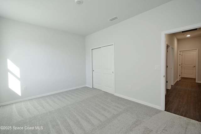 883 Parrotfish St SW, Palm Bay, FL 32908 - unfurnished bedroom with baseboards, carpet floors, and a closet