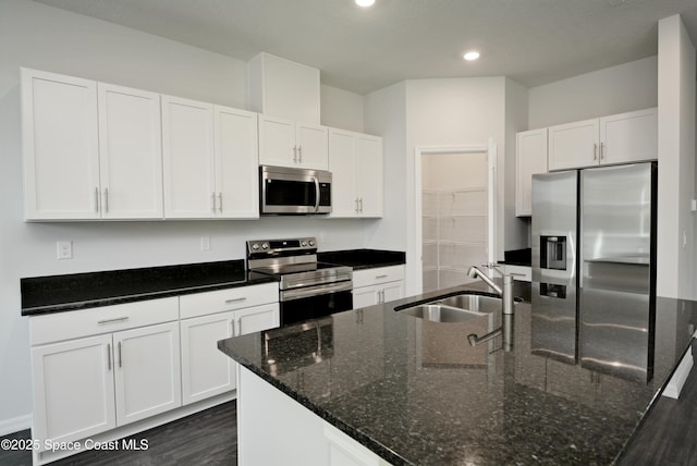 883 Parrotfish St SW, Palm Bay, FL 32908 - kitchen featuring appliances with stainless steel finishes, a sink, white cabinets, a center island with sink, and dark wood-style flooring