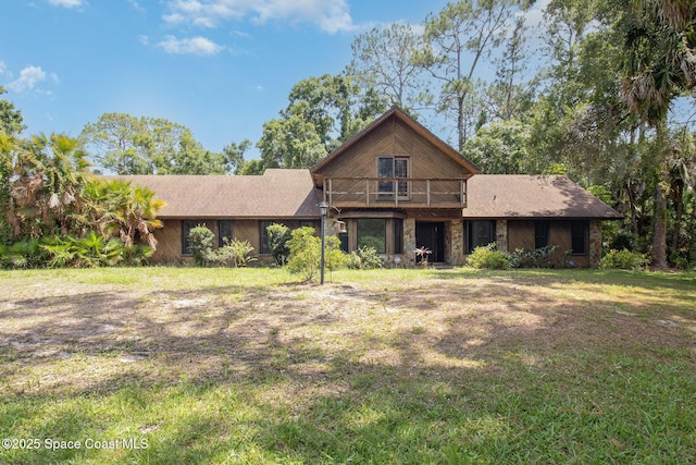 4121 Mustang Rd, Melbourne, FL 32934 - view of front facade featuring a front yard and stone siding