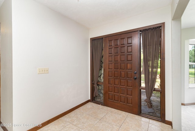 4121 Mustang Rd, Melbourne, FL 32934 - foyer featuring baseboards and light tile patterned floors