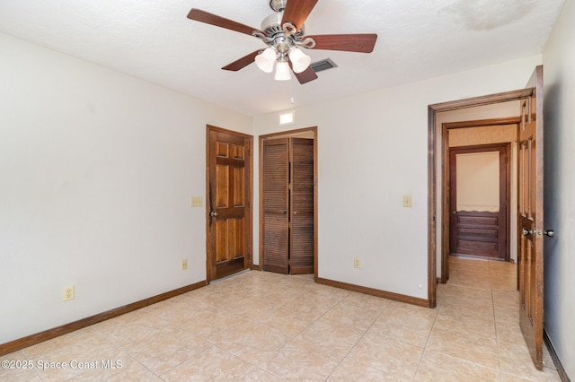 4121 Mustang Rd, Melbourne, FL 32934 - unfurnished bedroom with a closet, baseboards, and light tile patterned floors