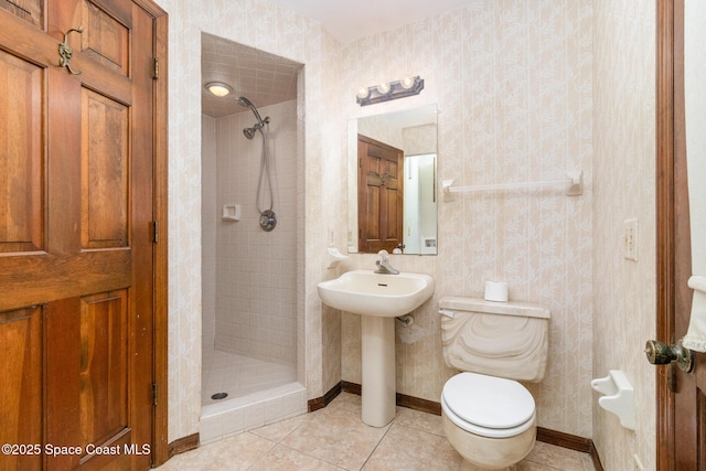 4121 Mustang Rd, Melbourne, FL 32934 - full bathroom featuring a shower stall, toilet, tile patterned floors, baseboards, and a sink