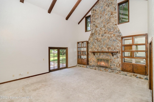 4121 Mustang Rd, Melbourne, FL 32934 - unfurnished living room with high vaulted ceiling, carpet, beamed ceiling, a stone fireplace, and french doors