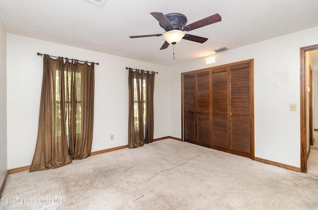 4121 Mustang Rd, Melbourne, FL 32934 - unfurnished bedroom featuring carpet, a closet, baseboards, and ceiling fan