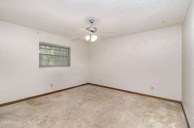 4121 Mustang Rd, Melbourne, FL 32934 - spare room with light carpet, a ceiling fan, and baseboards