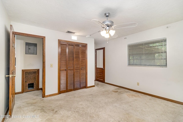 4121 Mustang Rd, Melbourne, FL 32934 - unfurnished bedroom with light carpet, a closet, electric panel, baseboards, and a textured ceiling