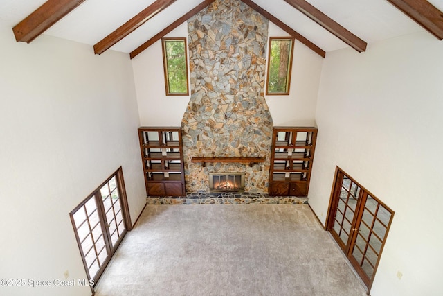4121 Mustang Rd, Melbourne, FL 32934 - unfurnished living room with high vaulted ceiling, beamed ceiling, carpet, a fireplace, and plenty of natural light